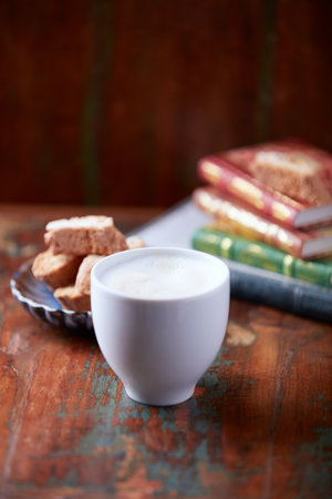 Cup of cappuccino with cookies on a wooden backgroundの写真素材
