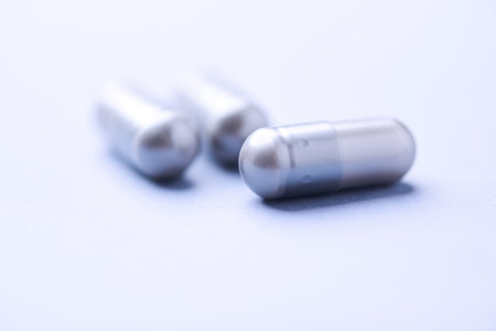 Close up of capsules on white background. Focus on foreground, soft bokeh.