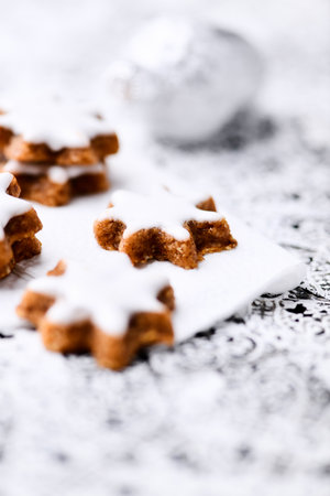 Traditional Christmas cookies with icing sugar on a wooden background. Selective focus.の写真素材