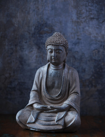 Old buddha statue on dark grunge background, close upの写真素材