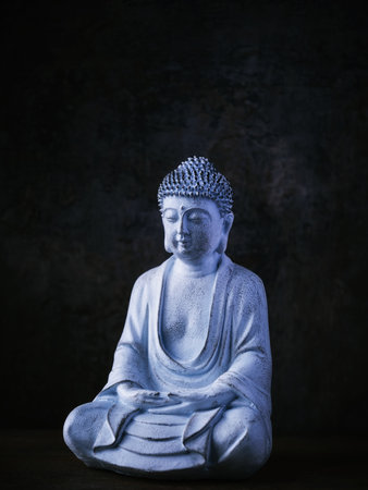 Buddha statue on dark background. Copy space for text.の写真素材