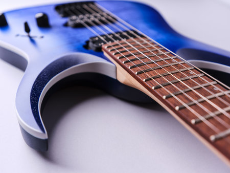 Blue electric guitar on a white background. Close-up. Studio shot.