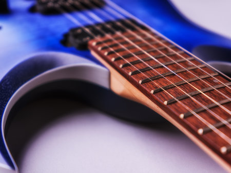 Blue electric guitar on a white background. Close-up, selective focus.の写真素材