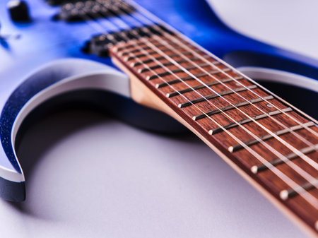 Blue electric guitar on a white background. Close-up, selective focus.の写真素材