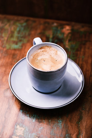 Coffee cup on wooden table in coffee shop, stock photoの写真素材
