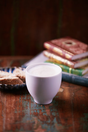 Cup of coffee and cookies on a wooden table, selective focusの写真素材