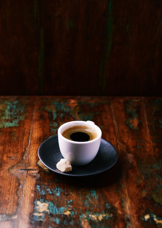 Cup of coffee on old wooden table. Selective focus.の写真素材