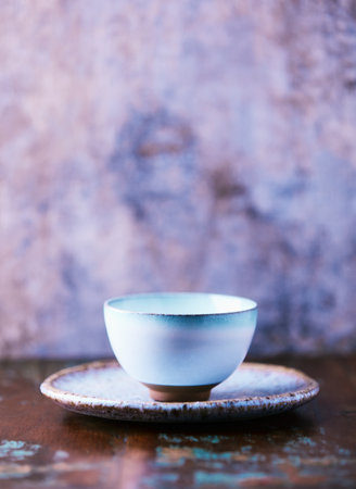 Traditional japanese ceramic on rustic wooden background. Soft focus. Copy space.の写真素材