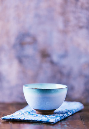 Traditional japanese ceramic on rustic wooden background. Soft focus. Copy space.の写真素材