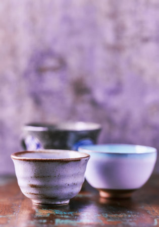 Traditional japanese ceramic on rustic wooden background. Soft focus. Copy space.の写真素材