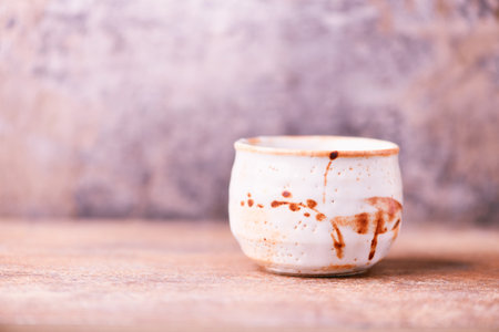 Traditional japanese ceramic on rustic wooden background. Soft focus. Copy space.の写真素材
