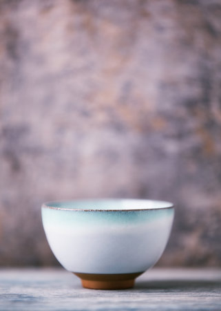 Traditional japanese ceramic on rustic wooden background. Soft focus. Copy space.の写真素材