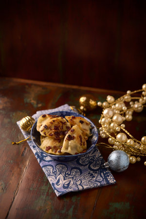 cookies with raisins in a bowl on a wooden background