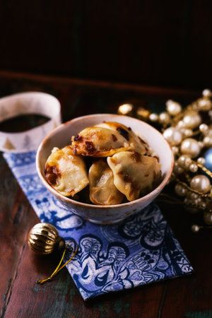Fried dumplings stuffed with meat and cheese in a ceramic bowl. Selective focus.