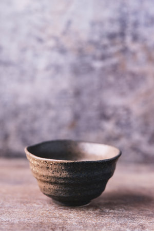 Traditional japanese ceramic on rustic wooden background. Soft focus. Copy space.