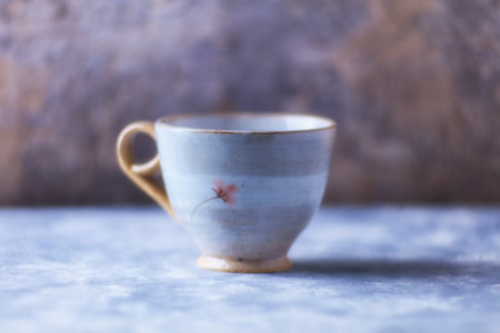 Ceramic cup on a blue background. Selective focus.の写真素材