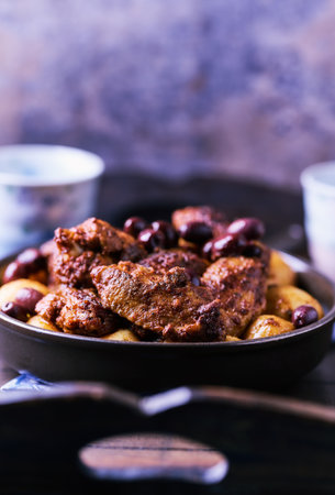 Fried chicken wings with potatoes on a rustic background. Soft focus.の写真素材