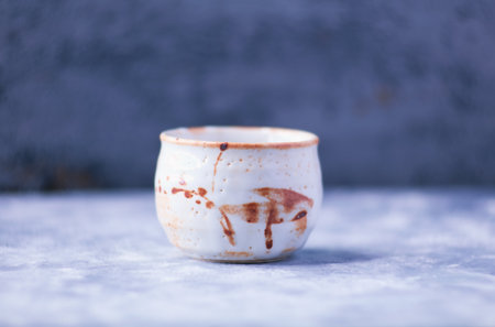 Ceramic cup on a blue background. Selective focus.の写真素材