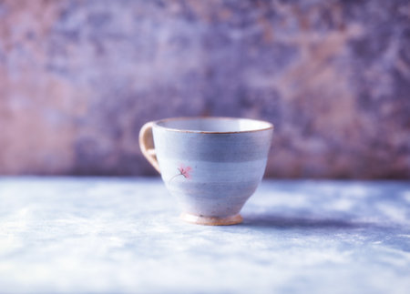 Ceramic cup on a blue background with copyspace.の写真素材
