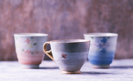 Ceramic cups on a wooden background. Selective focus.の写真素材