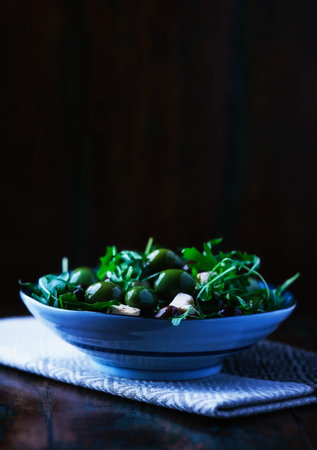 Green salad in a bowl on a wooden background. Selective focus.の写真素材