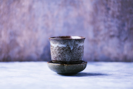 Ceramic cup and saucer on blue background. Selective focus.の写真素材