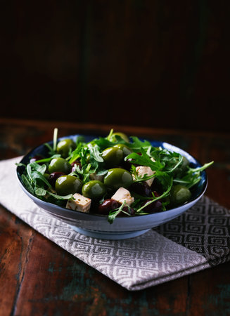 Green salad with feta cheese, olives and arugulaの写真素材