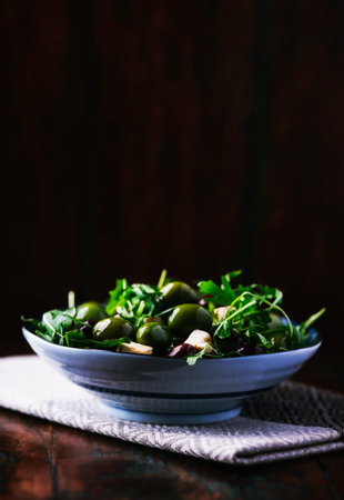 Green salad with arugula, olives and garlic. Selective focusの写真素材