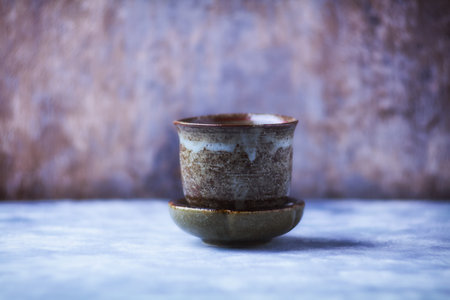 Ceramic cup and saucer on blue background. Selective focus.の写真素材
