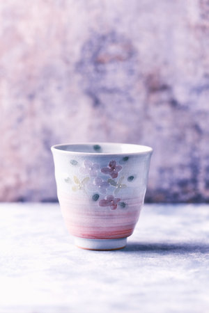 Vintage porcelain tea cup on a stone background. Selective focus.の写真素材