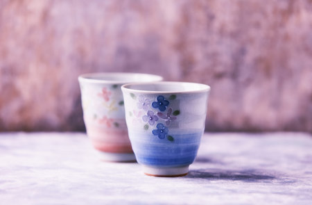 Two ceramic cups for tea or coffee on a light background. Selective focus.の写真素材