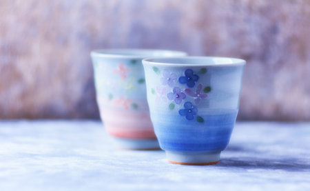 Ceramic cups on a blue background. Selective focus.の写真素材