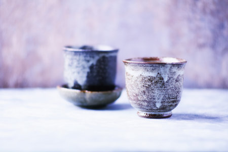Two ceramic cups of coffee on a wooden background. Selective focus.の写真素材