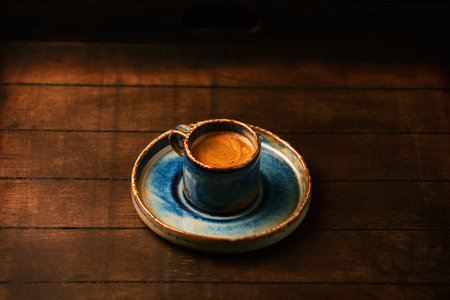 Cup of coffee on a wooden table. Vintage style toned pictureの写真素材