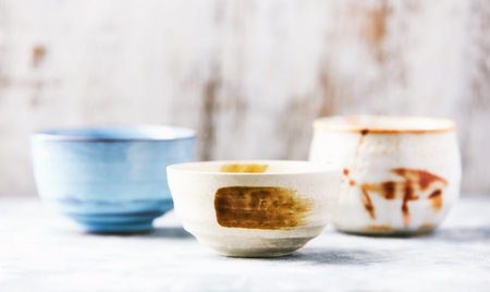 Ceramic bowls on a wooden background. Selective focus.