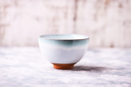 Ceramic bowl on a white background. Selective focus.