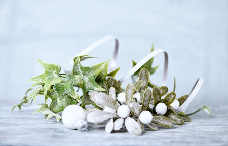 Christmas decoration with mistletoe on a wooden background with copy space