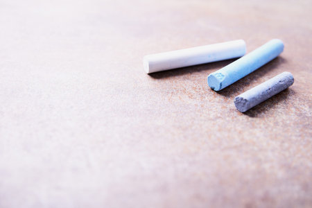 Colorful chalks on a rusty metal background. Selective focus.