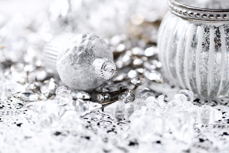 Silver christmas decoration on a silver background. Shallow depth of field.