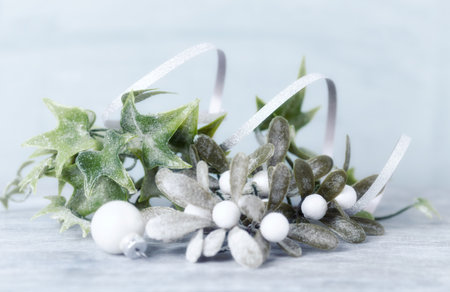 Christmas decoration with mistletoe on wooden background, close-up