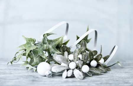 Christmas decoration with mistletoe on wooden background, copy space.