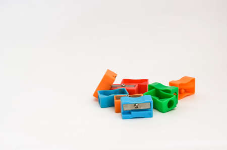 different colors sharpener on white background with copy space.