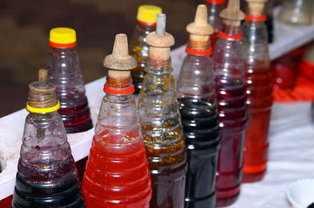plastic bottles with syrup to make colorful summer slushiesの写真素材