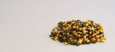 Crunchy Roasted Chana Masala, made with Bengal Grams or Chickpeas. Pile of Indian spicy snacks (Namkeen), under top lighting, side view, against the white background.の写真素材