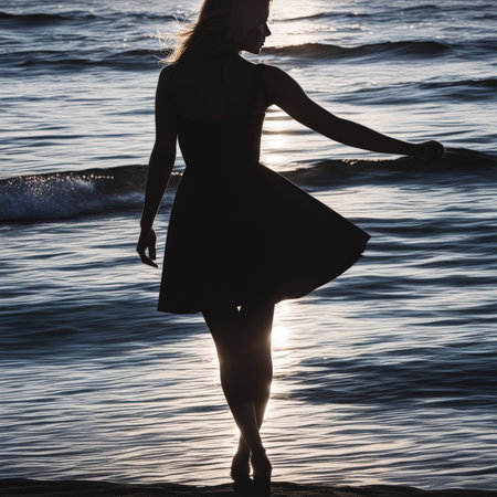 beautiful girl with long hair on the beach at sunsetの素材