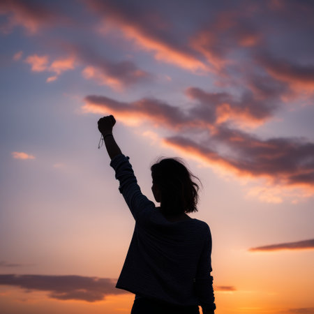 young woman with raised handsの素材