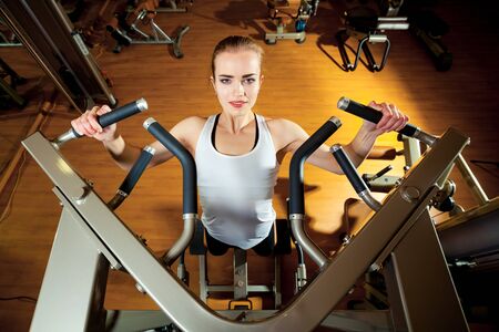 Woman working out in gym - pull ups.の写真素材