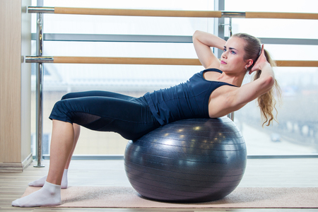 Young girl working out at the gym with a ball.の写真素材