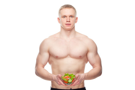 Shaped and healthy body man holding a fresh salad bowl,shaped abdominal, isolated on white background, colored retouchedの写真素材