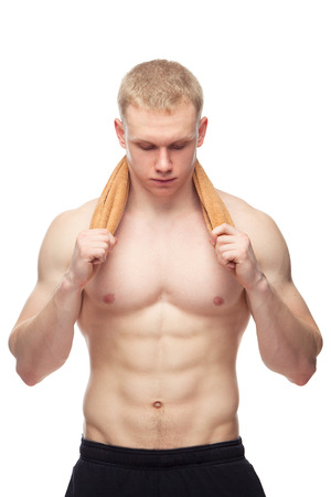 Happy muscular guy with towel over white background.の写真素材
